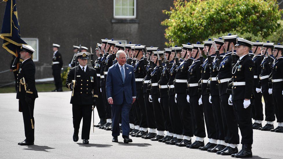 Prince of Wales inspects an honour guard during visit to Cork Naval Base
