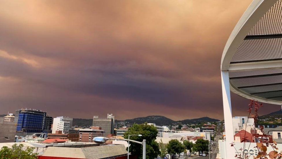 Smoke-filled red clouds blanket the city of Hobart
