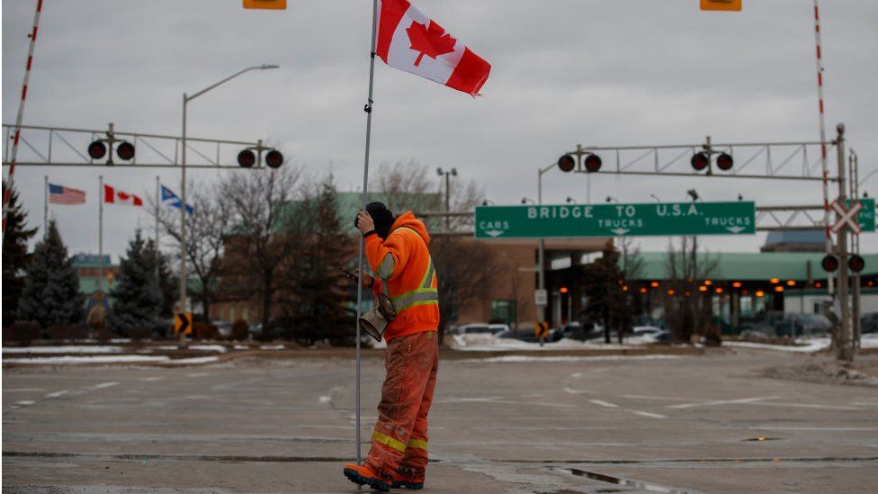 Protestors and supporters attend a blockade at the foot of the Ambassador Bridge, sealing off the flow of commercial traffic over the bridge into Canada from Detroit