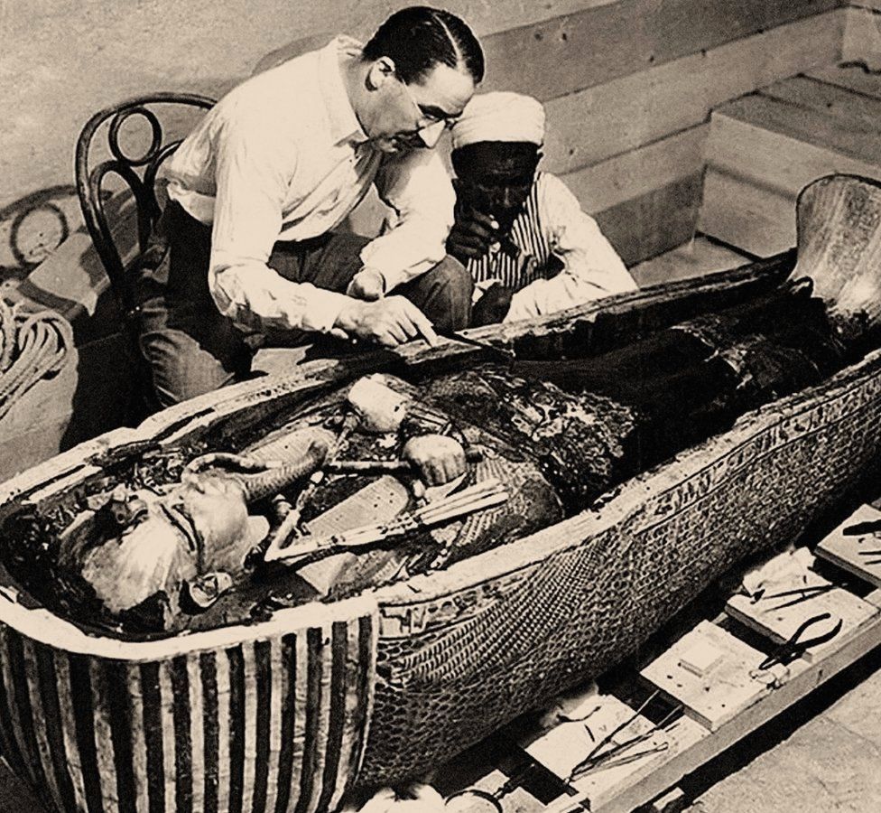 Howard Carter inspects the coffin of Tutankhamun, 1925
