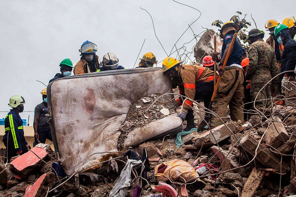 Firefighters remove debris in search of survivors in Les Cayes, Haiti on 17 August 2021