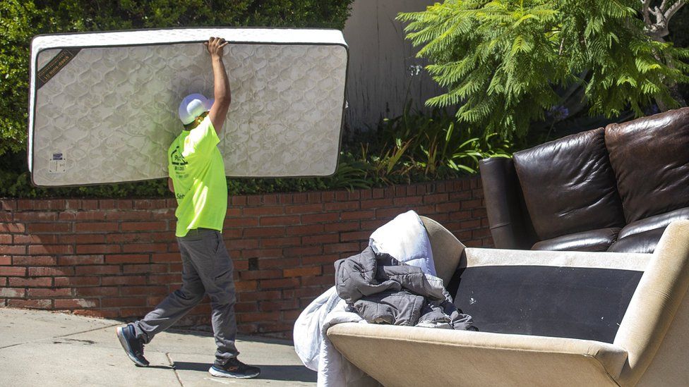 A pile of discarded furniture outside a apartment building in Los Angeles 2023