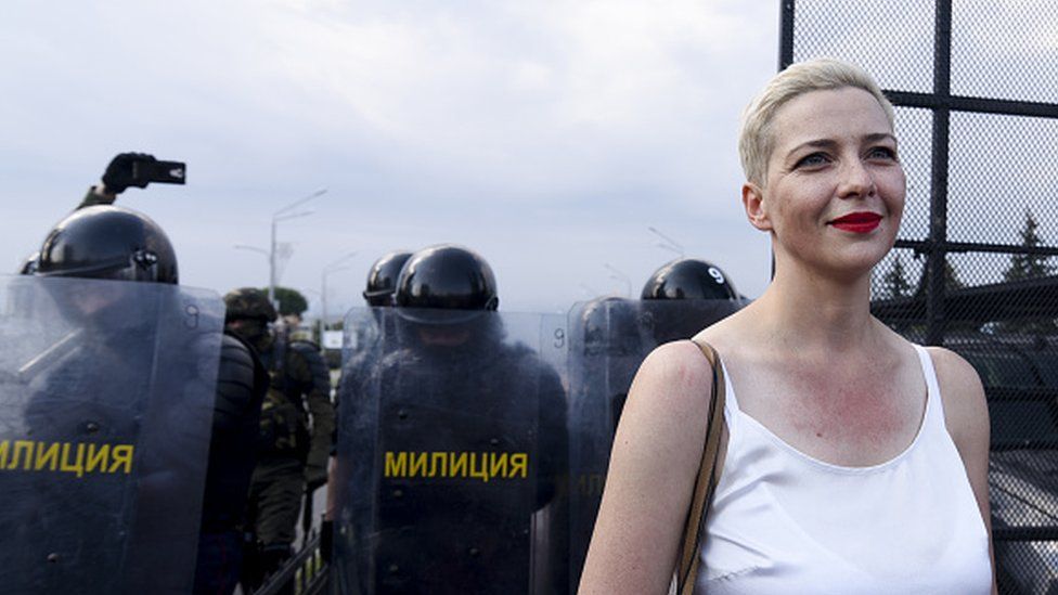 Maria Kolesnikova at a protest, with riot police seen behind her
