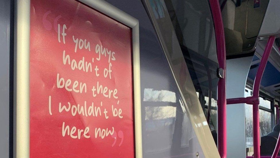 A red poster in a bus saying "If you guys hadn't of been there I wouldn't be here now"