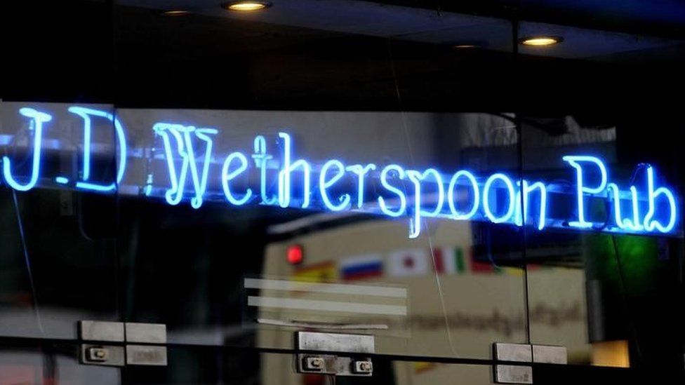 a neon sign in a JD Wetherspoon pub in London