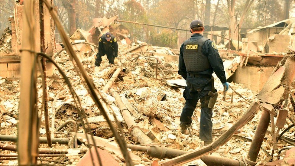 Coroners search the wreckage of a home
