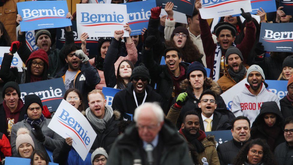 Sanders supporters listen to him speak at a rally in March 2019