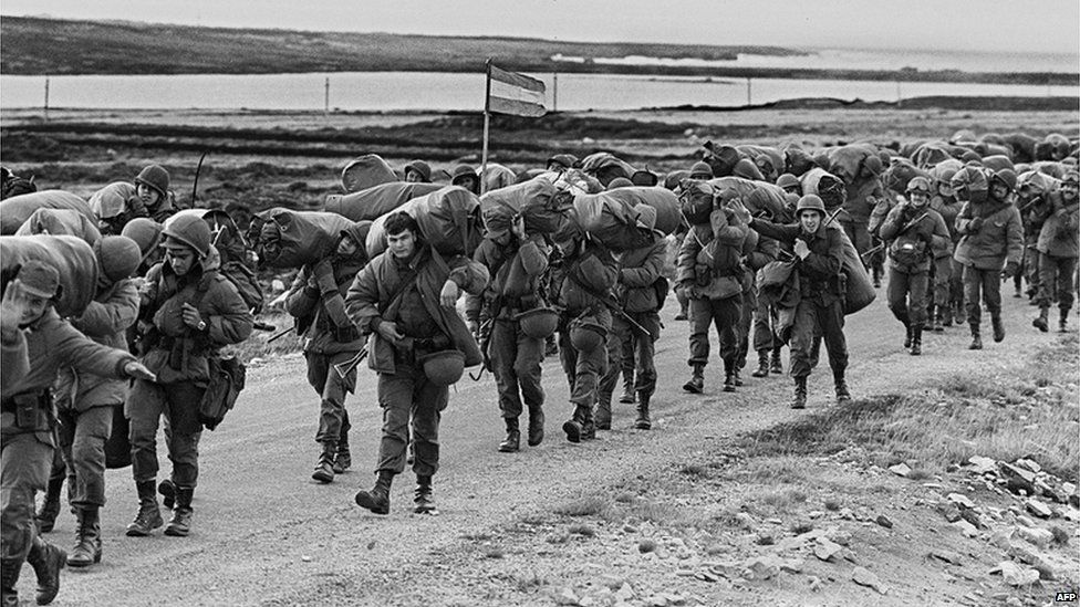 Argentine soldiers (troops) walking on their way to occupy the captured Royal Marines base in Puerto Argentino/Port Stanley