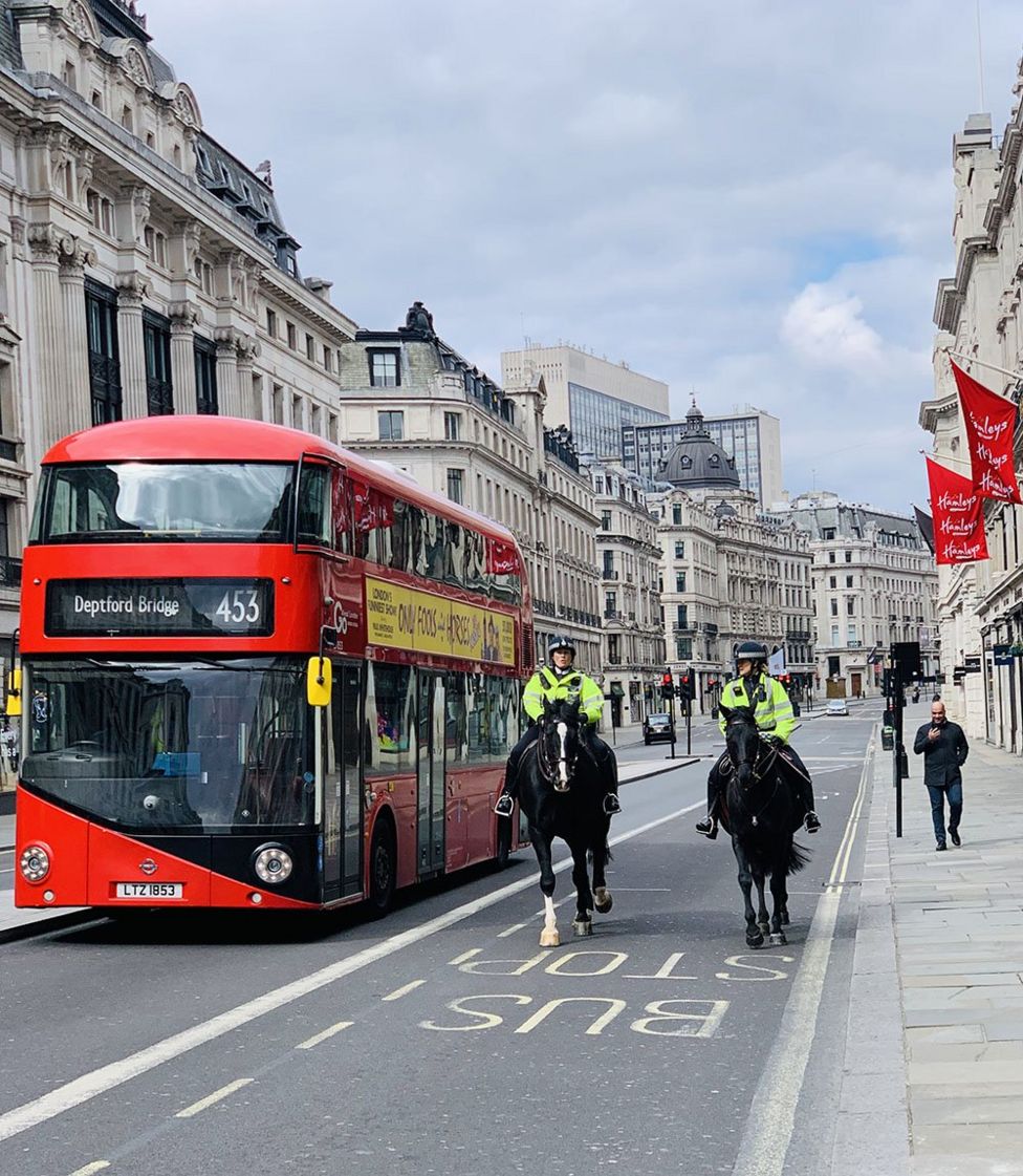 Mounted police and a London bus