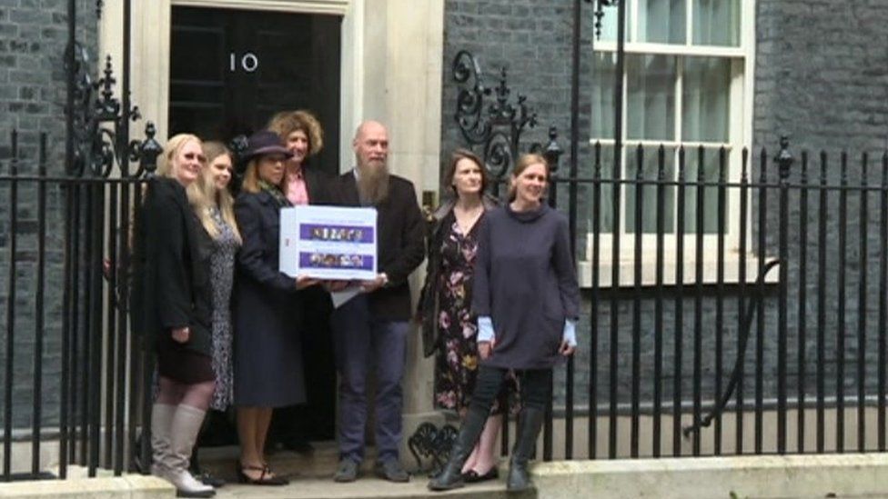 Parents handing in a petition at Downing Street