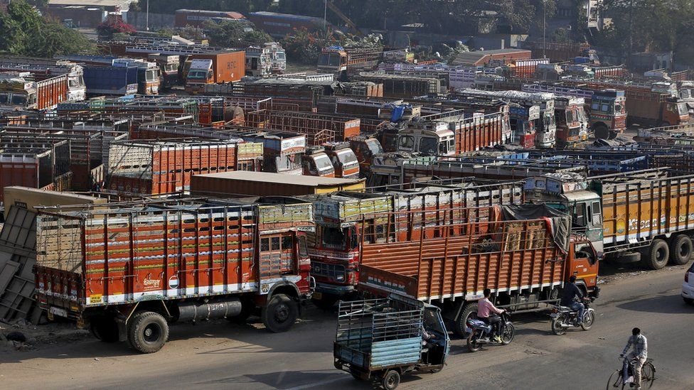 Trucks are seen parked in an open plot near a national highway on the outskirts of Ahmedabad, India, December 2, 2015.