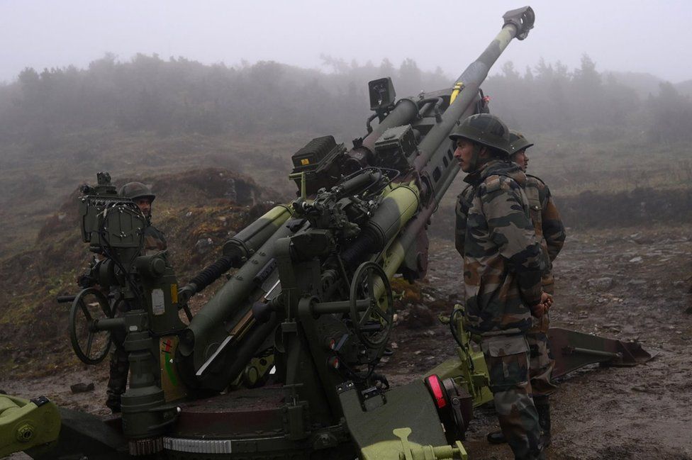 Indian Army soldiers stand next to a M777 Ultra Lightweight Howitzer positioned at Penga Teng Tso ahead of Tawang, near the Line of Actual Control (LAC), neighbouring China, in India's Arunachal Pradesh state on October 20, 2021.