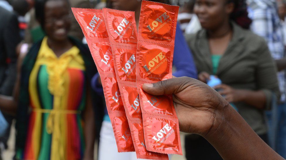 Someone distributing condoms - archive shot