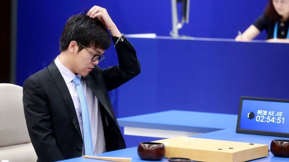 China's 19-year-old Go player Ke Jie reacts during the first match against Google's artificial intelligence programme AlphaG