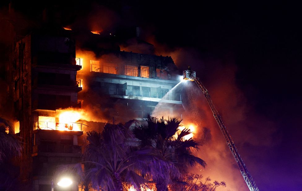 Firefighters work at the scene of a fire at an apartment building in Valencia, Spain. February 22, 2024.