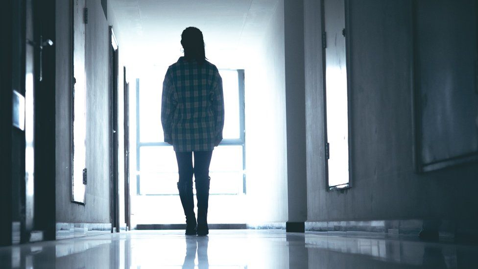 Silhouette of a young girl in a corridor