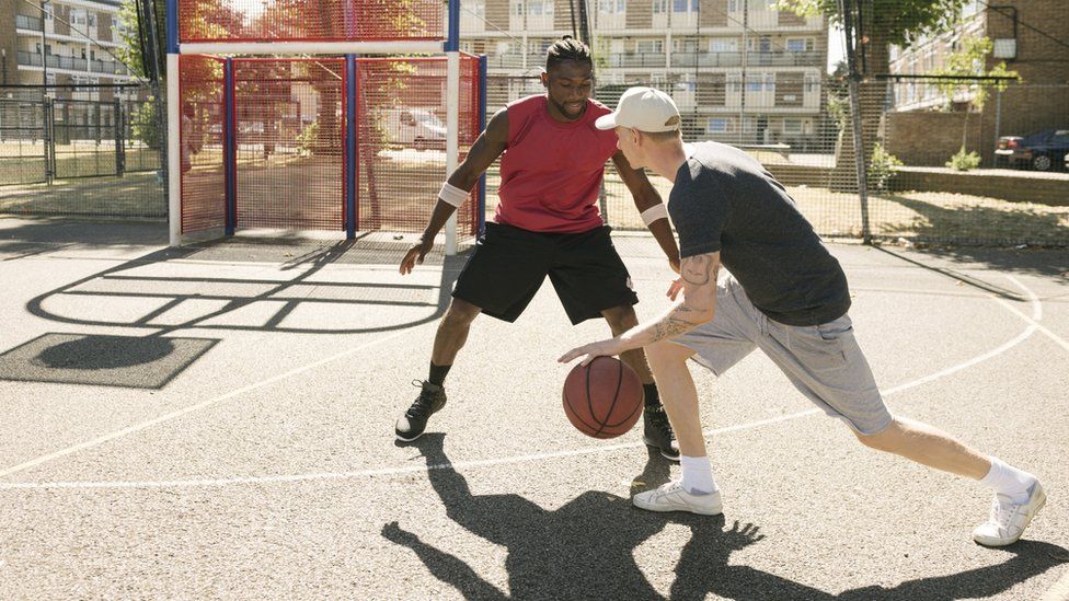 Friends playing basketball