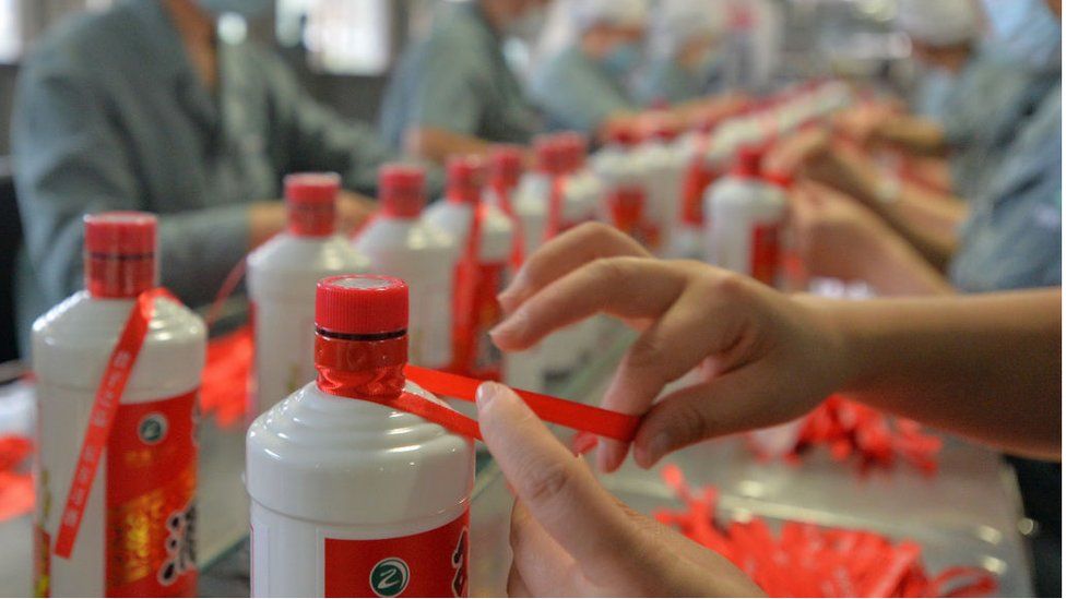Employees package Kweichow Moutai at a factory in China.