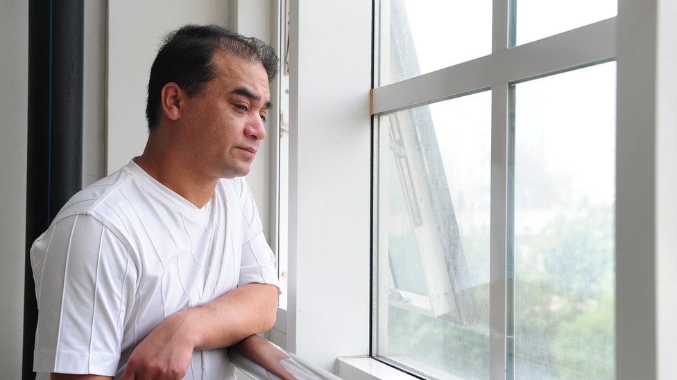 University professor, blogger, and member of the Muslim Uighur minority Ilham Tohti pauses for a few moments for a view from the window before a classroom lecture in Beijing on 12 June 2010.