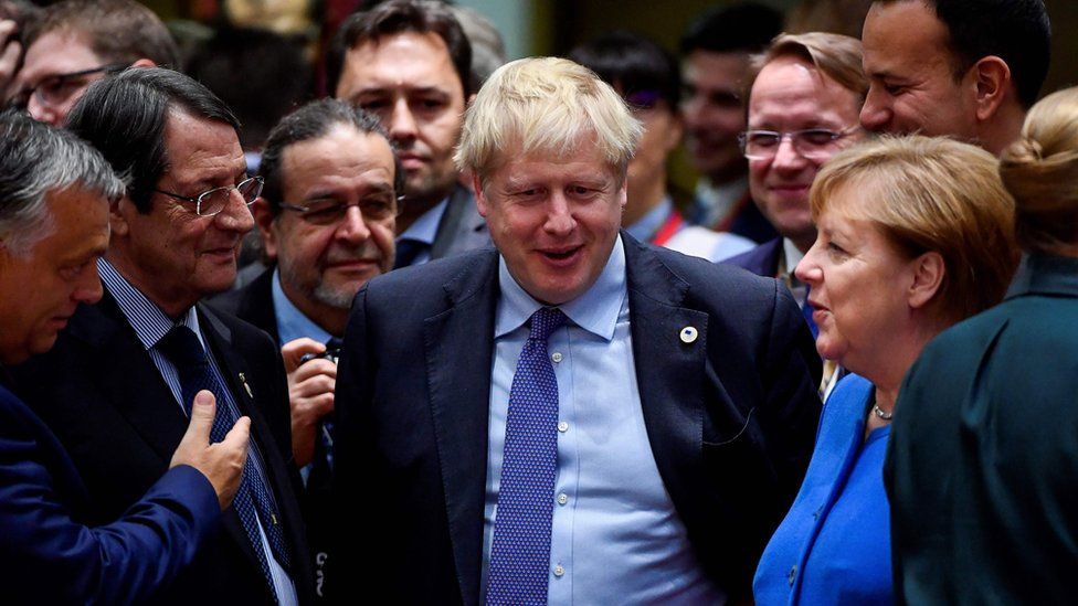 Boris Johnson was surrounded by EU leaders after the deal was announced at the Brussels summit