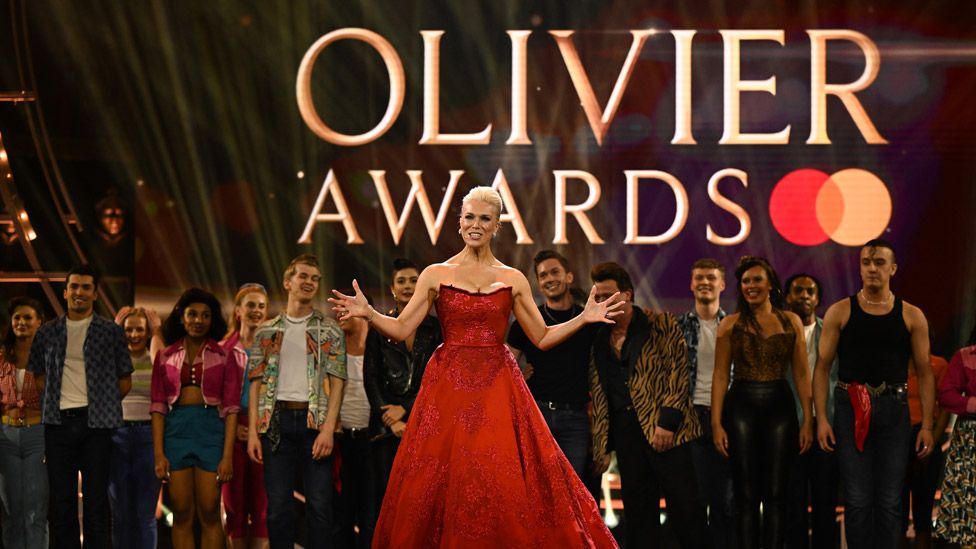 Host Hannah Waddingham with the cast of Grease at the finale of The Olivier Awards 2023 at the Royal Albert Hall on April 02, 2023 in London
