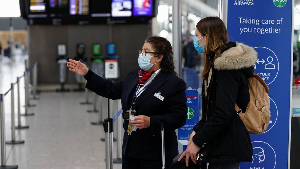 Passenger and staff at Heathrow Airport