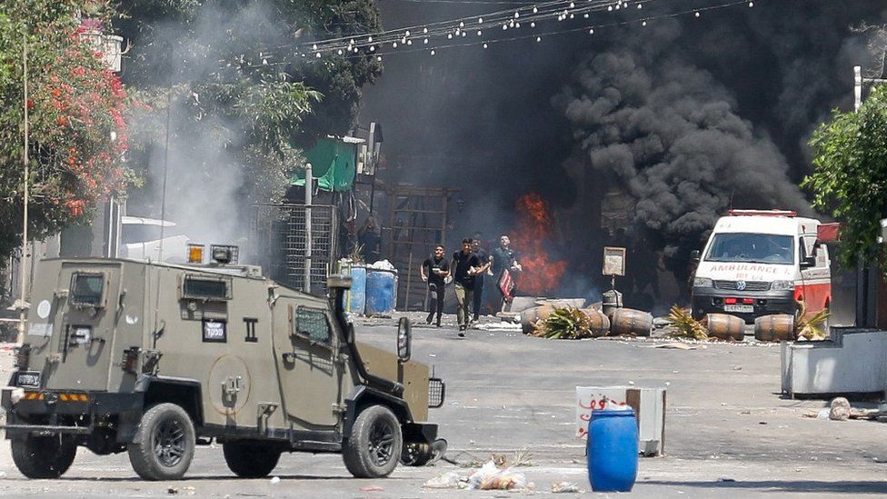 Israeli military vehicle confronting Palestinian youths in Jenin, 3 Jul 23