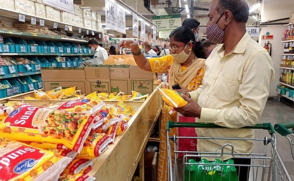 Shoppers purchase packets of vegetable oil at a supermarket in Mumbai, India, March 7, 2022.