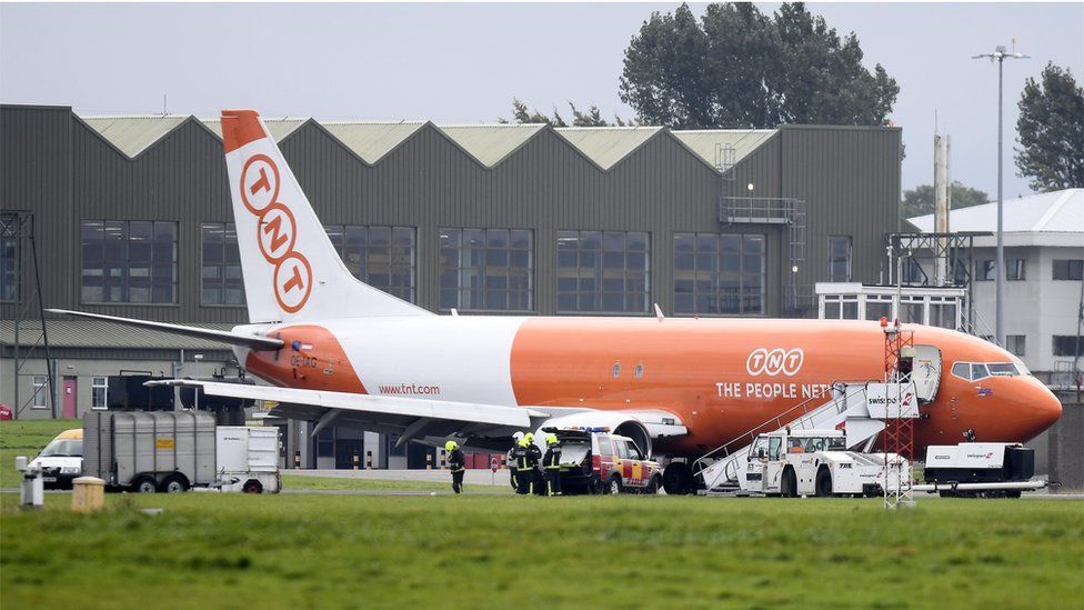 A cargo plane with burst tyres got stuck on the runway at Belfast International Airport