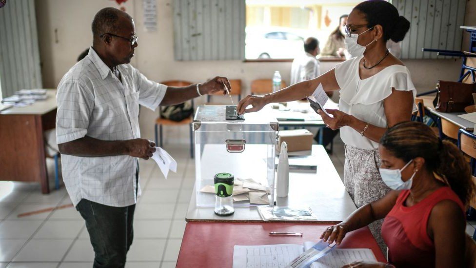A voter casts his ballot at a polling station as he votes for the second round of the French parliamentary elections in Fort-de-France, on the French Caribbean island of Martinique, on June 18, 2022