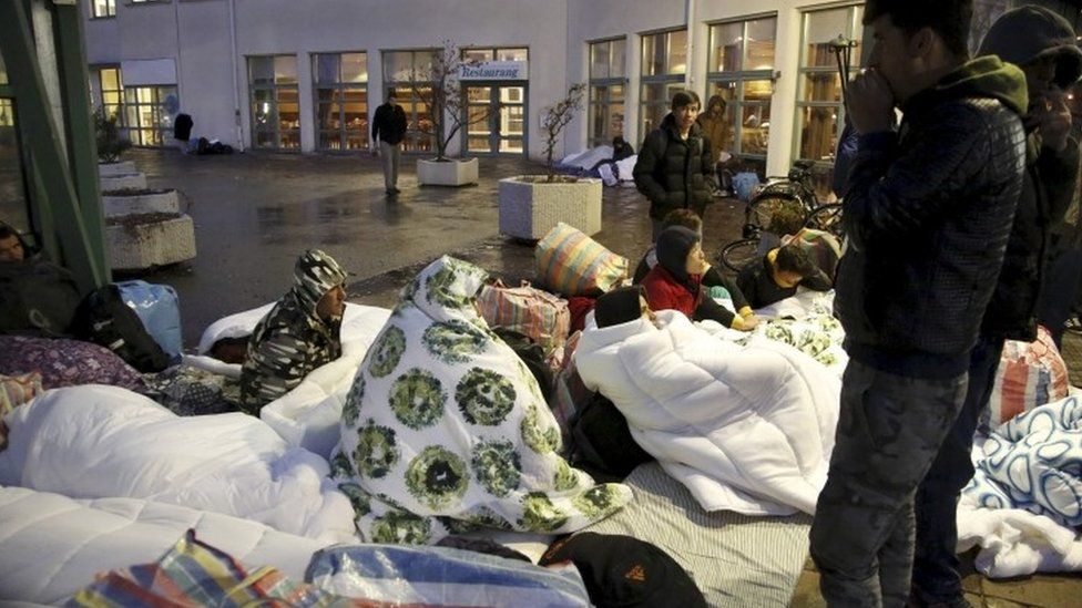 Refugees sleep outside an arrivals centre in Malmo, Sweden