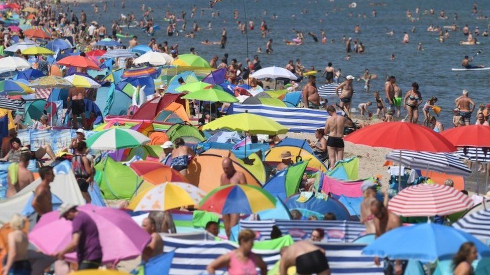 People crowd a beach on the island of Usedom, northern Germany