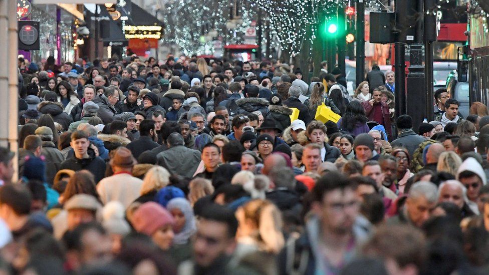 File photos of crowds on Oxford Street in London.