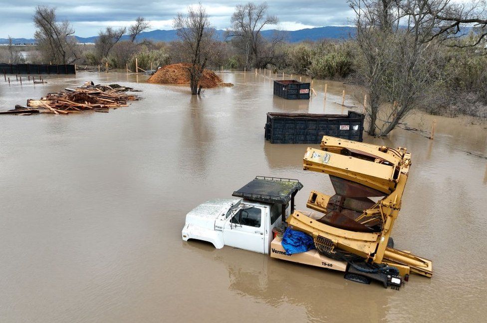 Farming equipment submerged in floodwater in Salinas