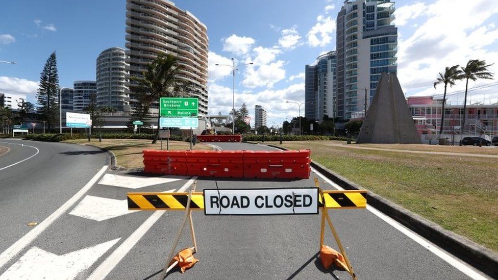 A road closed sign at the border between New South Wales and Queensland