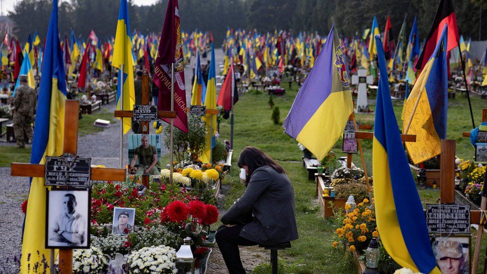 A woman cries at a cemetery in Lviv