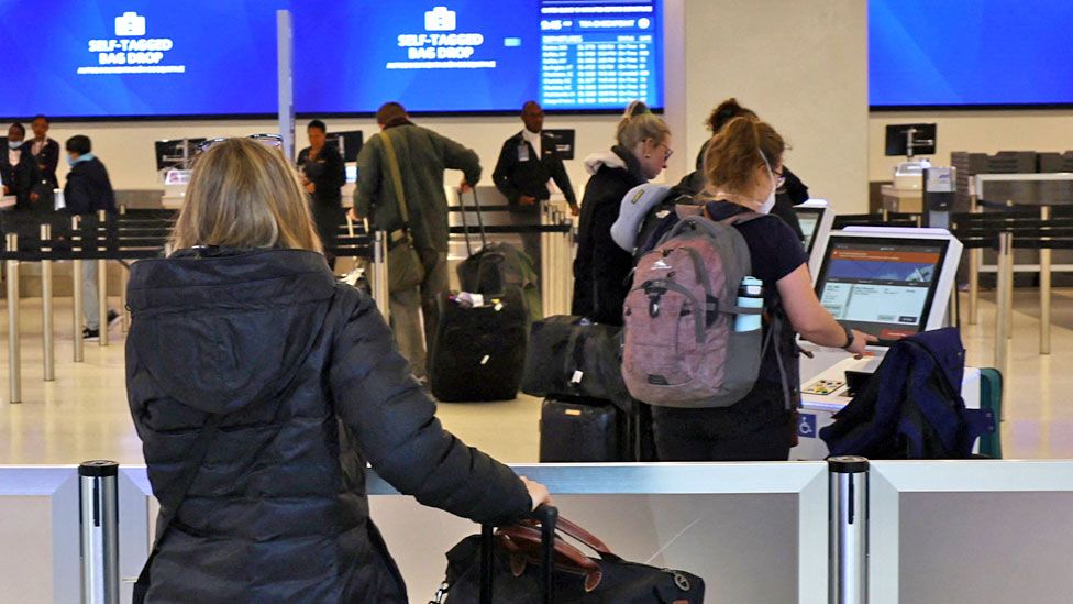 Passengers wait to check in inside the Delta Airlines terminal after flights were grounded during an FAA system outage at Laguardia Airport in New York City, New York, US on 11 January 11, 2023