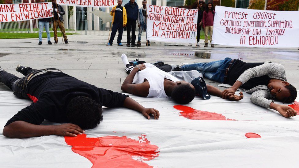 Ethiopians living in Germany protest against German Chancellor Angela Merkel's visit to Ethiopia - which they accuse of human rights violations - outside the federal chancellery in Berlin, Germany, on 8 October 2016