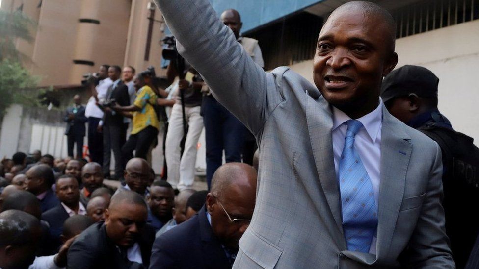 Former Congolese interior minister Emmanuel Ramazani Shadary waves to his supporters as he arrives to file his candidacy for the presidential election, at the Congo"s electoral commission (CENI) head offices at the Gombe Municipality in Kinshasa, Democratic Republic of Congo, August 8, 2018.