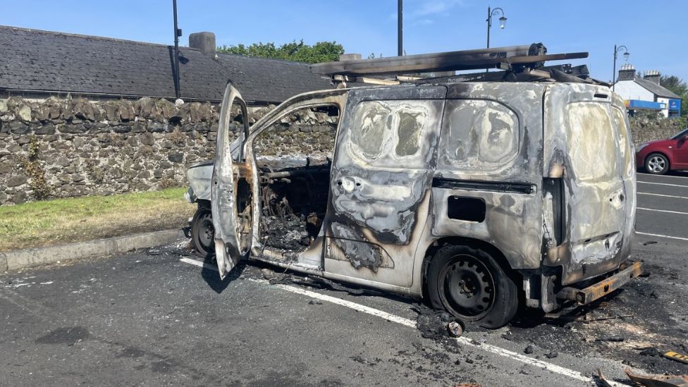 Remains of burned out van at car park in Bushmills