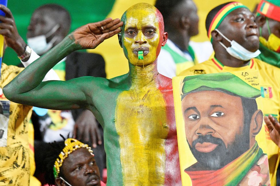 Malian supporters, one saluting with a portrait of Colonel Assimi Goïta at a stadium in Limbe, Cameroon - Wednesday 26 January 2022
