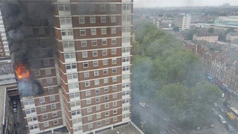 A fire rages in a flat in the Shepherd's Court tower block in west London