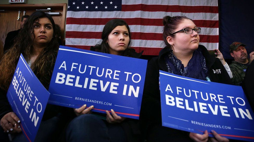 Bernie Sanders supporters holding placards reading "A future to believe in"