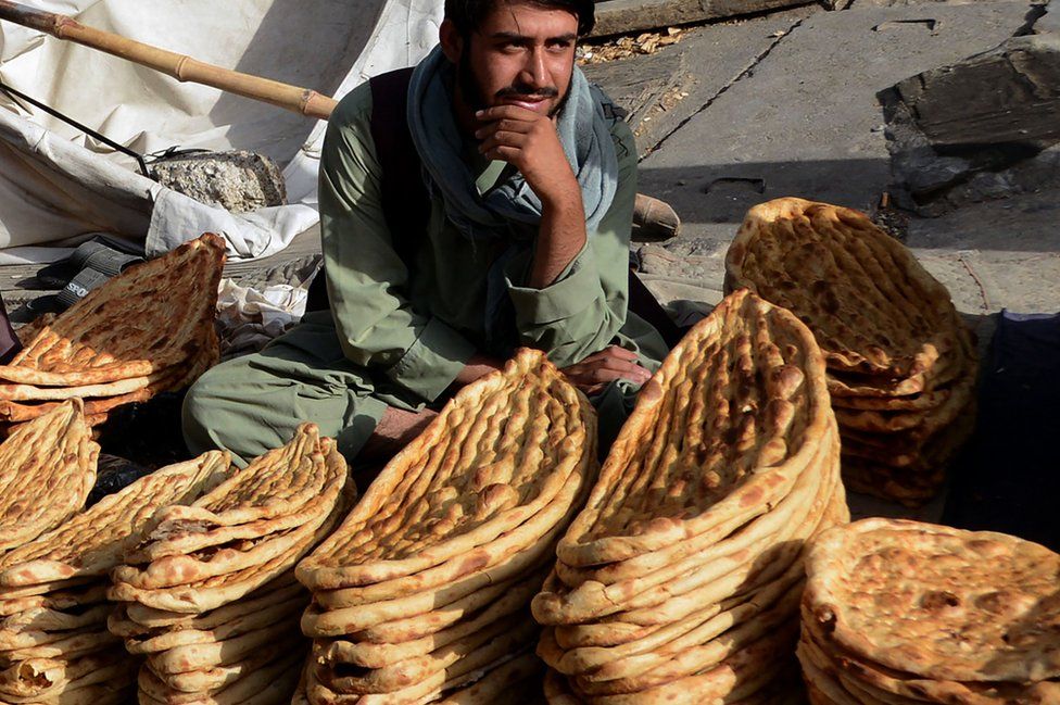 A roadside vendor selling bread waits for customers on the first day of holy fasting month of Ramadan in Kandahar on April 2, 2022.