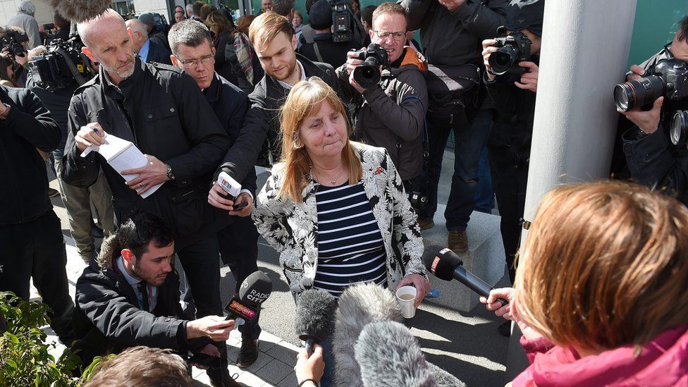 Margaret Aspinall reacts outside court