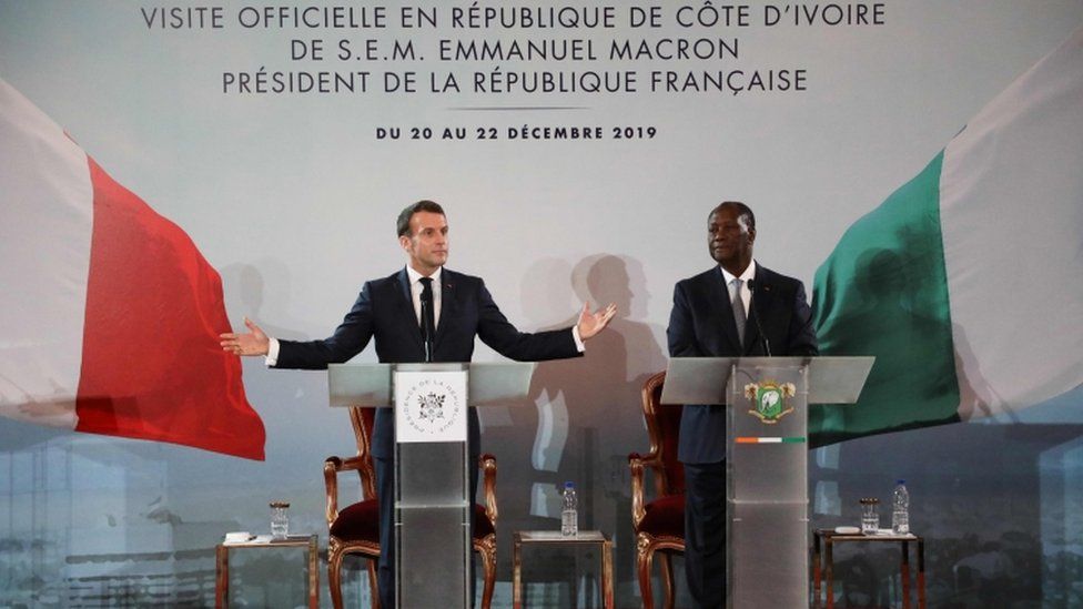 Emmanuel Macron (L) and Ivorian counterpart President Alassane Ouattara (R) hold a press conference at the Presidential Palace in Abidjan on December 21, 2019