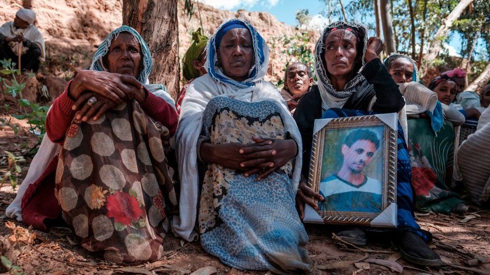 People mourn the victims of killings in the village of Dengolat in Tigray.
