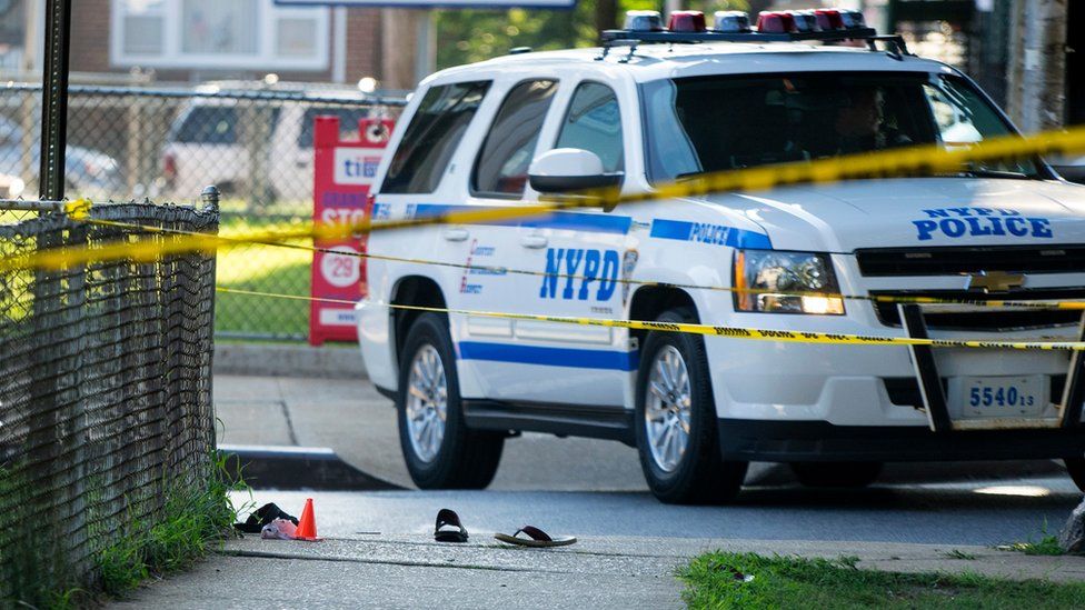 Sandals lay on a street corner at the crime scene, Saturday, Aug. 13, 2016, not far from the Al-Furqan Jame Masjid Mosque in the Ozone Park neighborhood of Queens, New York