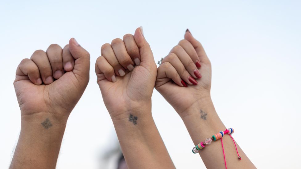During the Virgin Mary Festival in Dronka, Coptic Christians show crosses tattooed on their wrists.