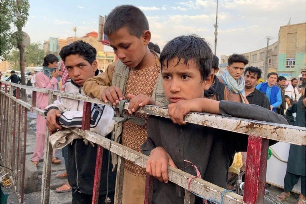 Afghan people gather at the scene after a bomb explosion in Kabul, Afghanistan, 13 July 2021.